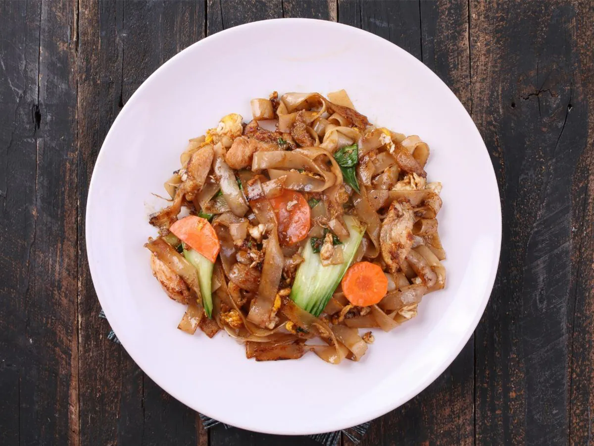 Wide rice noodles stir-fried with beef, veggies & egg at Dong bei Ren jia, a Asian Restaurant in Chicago