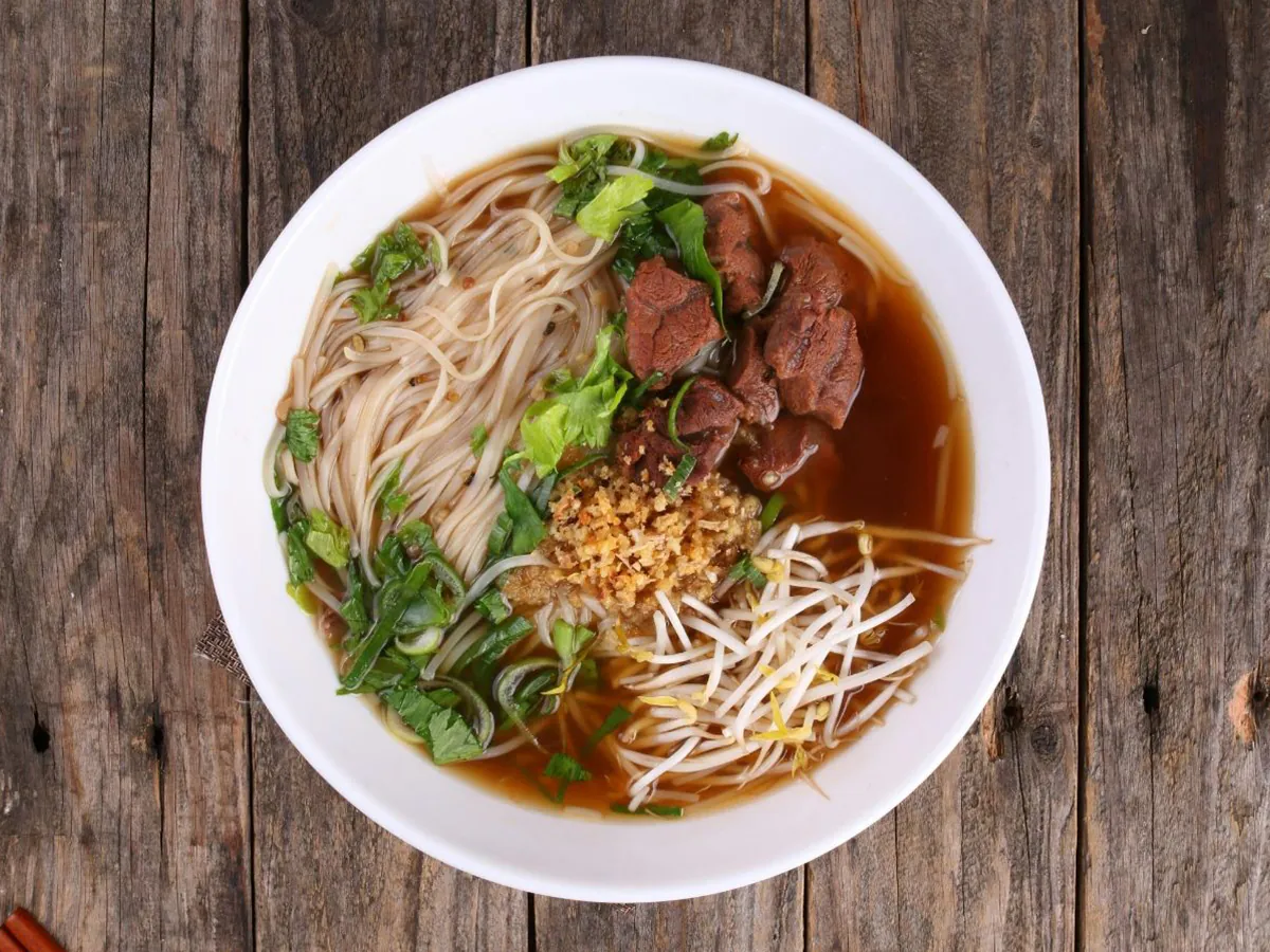 Tender beef in savory broth with rice noodles & greens at Dong bei Ren jia, a Asian Restaurant in Chicago